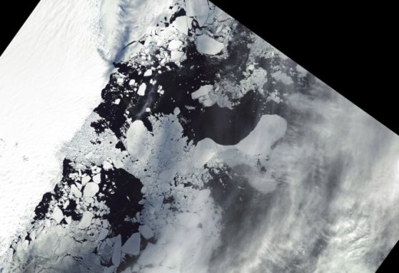 The Conger Ice Shelf is seen starting to break off from space, shown as a broken white mass in the ocean